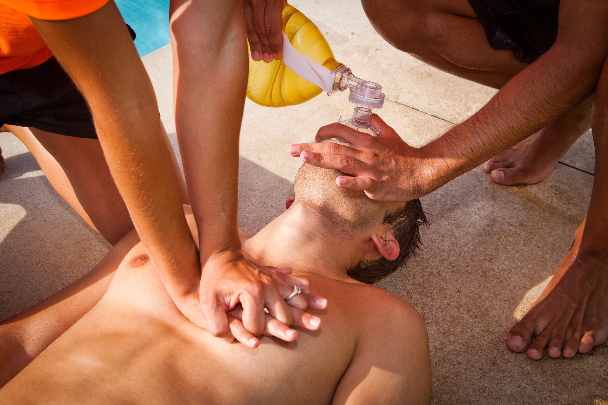 CPR at the pool by bystanders giving-cpr